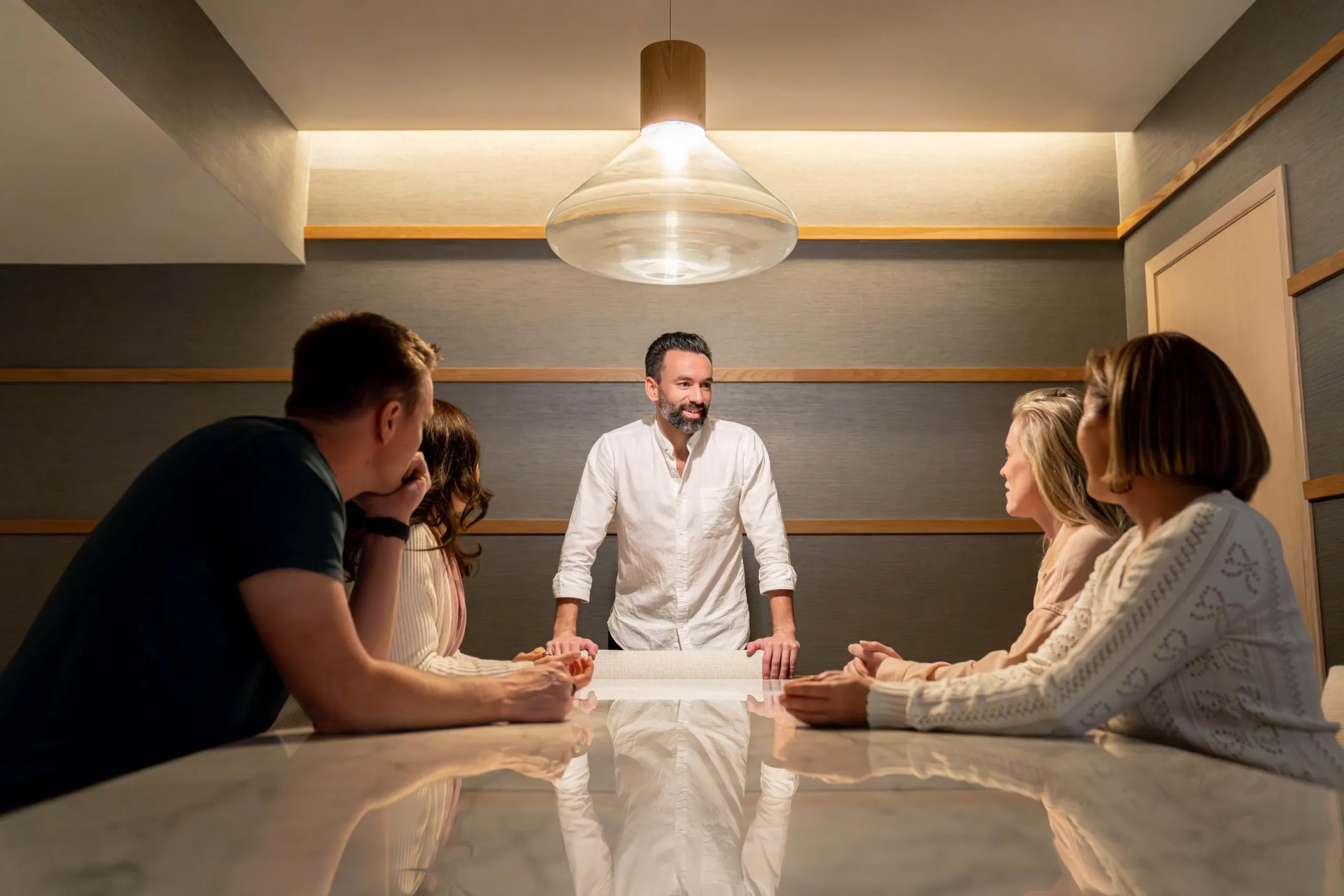 André Crabb leading a session with a small team around a conference table