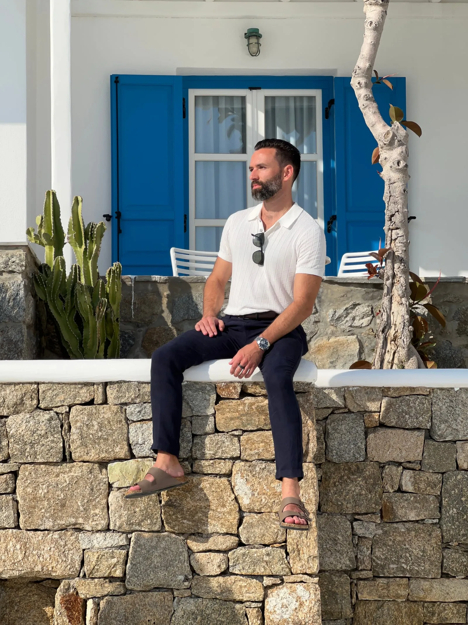 Sitting by a blue door, Mykonos, Greece